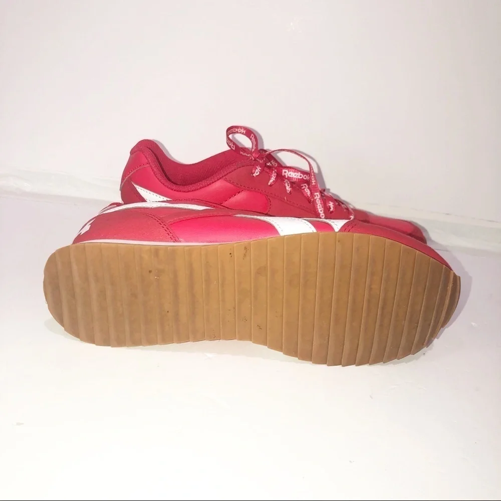 Reebok red classics with repeating logo strings.